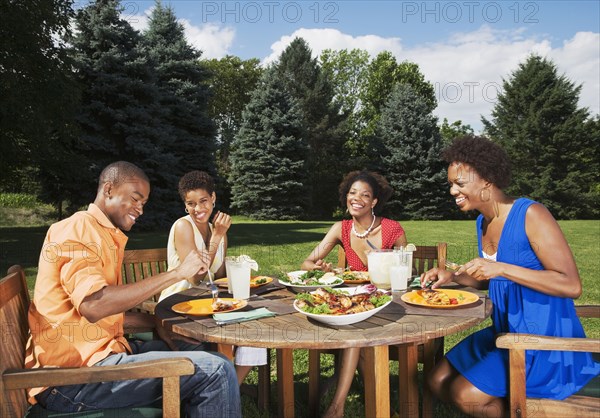 African American friends eating outdoors
