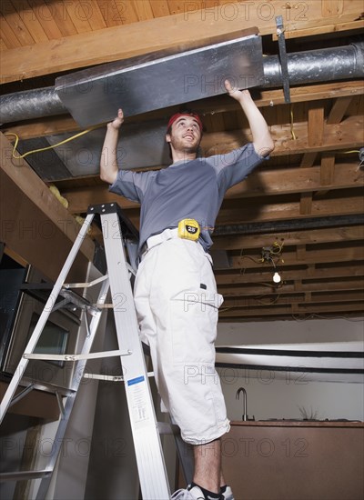 Middle Eastern man remodeling house