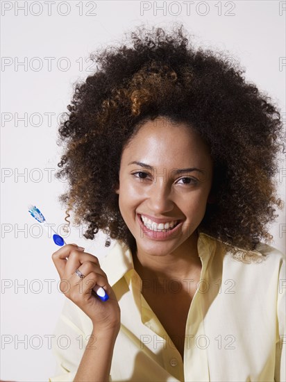 African woman holding toothbrush