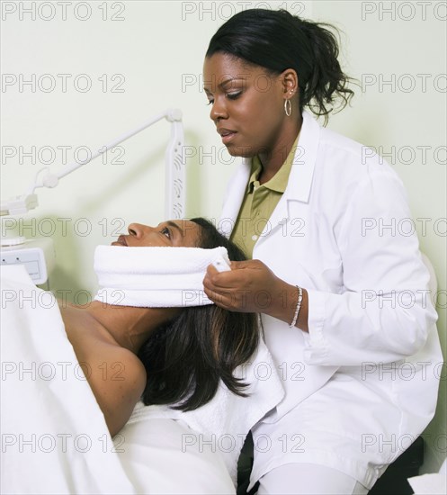 African woman receiving spa facial treatment