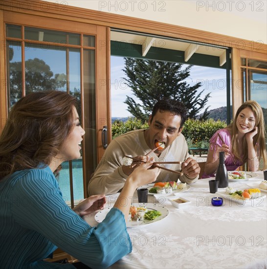 Multi-ethnic couples eating sushi