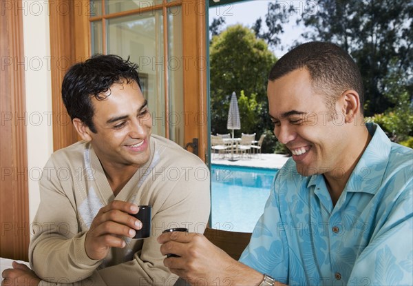 Multi-ethnic men toasting with sake