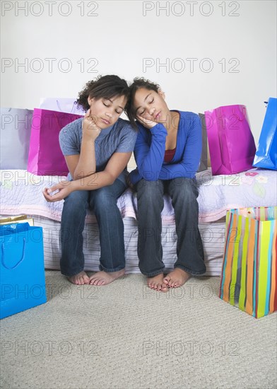 African twin sisters looking bored