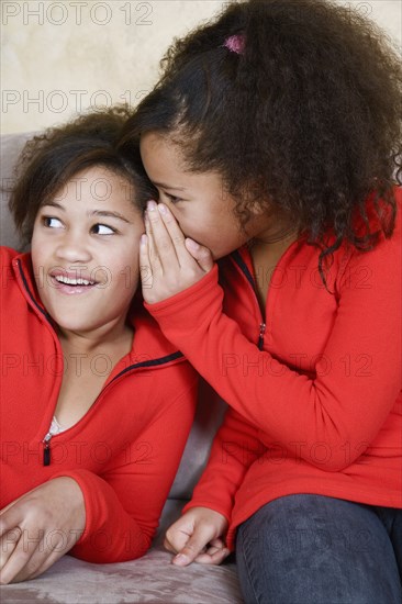 African twin sisters telling secret