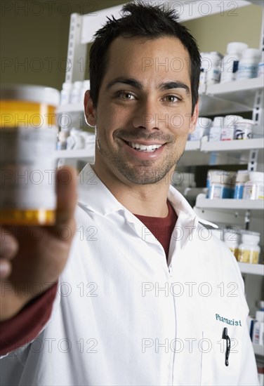 Pacific Islander pharmacist holding medication bottle