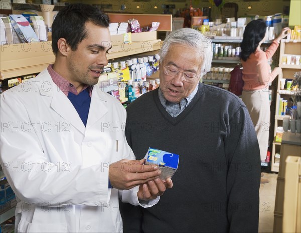 Pacific Islander pharmacist assisting customer