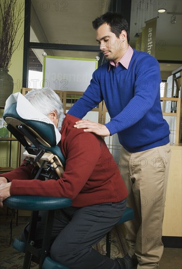 Pacific Islander massage therapist massaging client