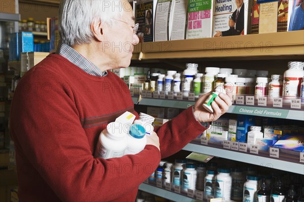 Senior Asian man shopping for natural medicine