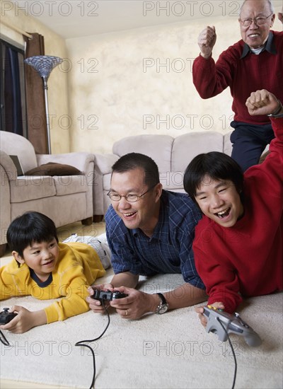 Multi-generational Asian family playing video games
