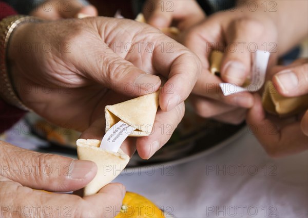 Asian family opening fortune cookies