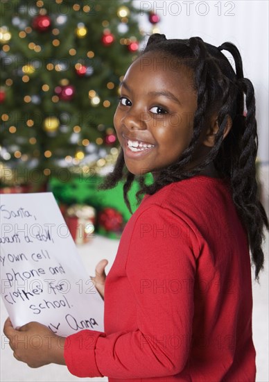 African girl holding letter for Santa Claus