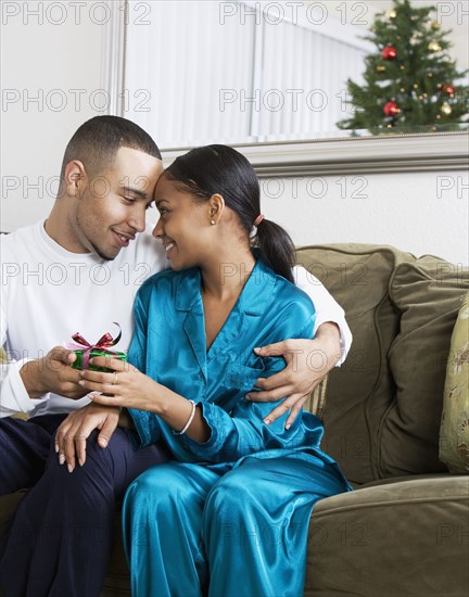 African couple holding gift