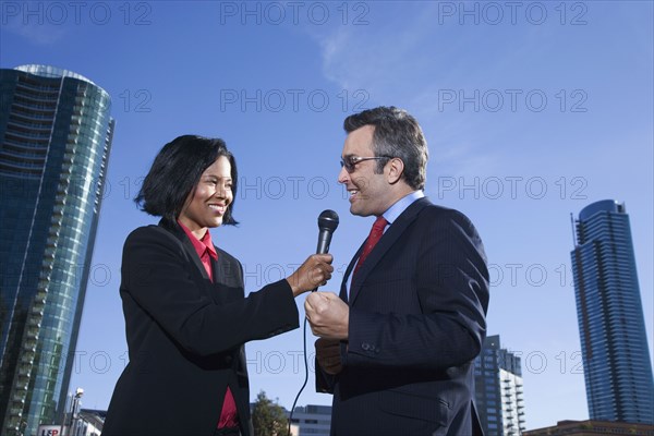 African female reporter interviewing businessman