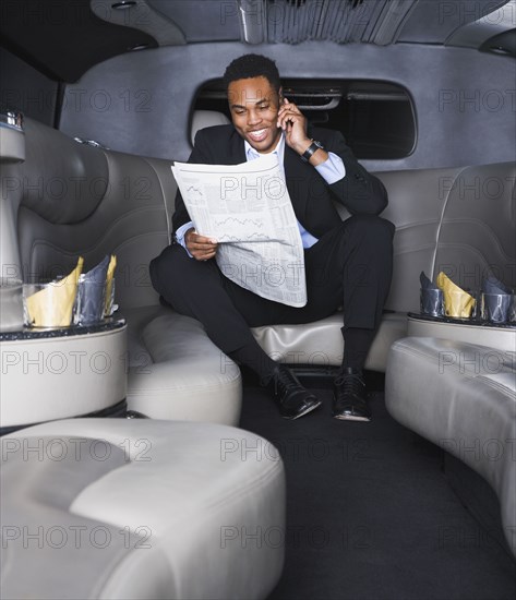 African businessman reading newspaper