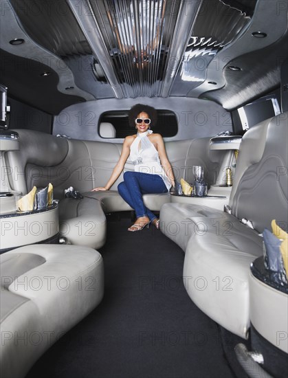 African woman sitting in limousine