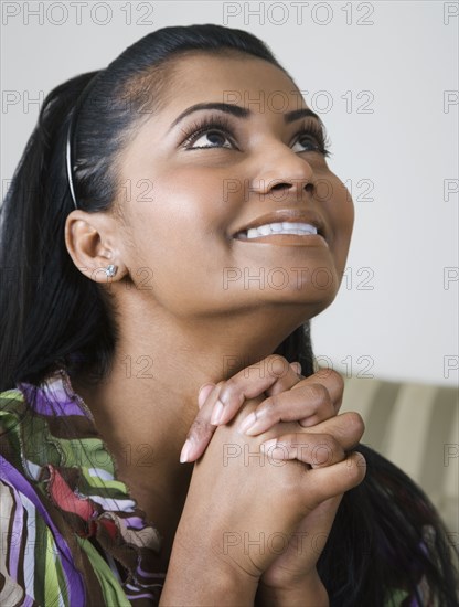 Mixed race woman praying