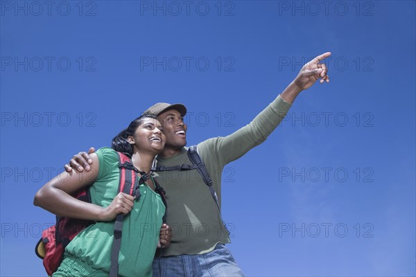 Multi-ethnic couple backpacking