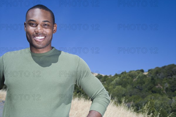 Mixed race man standing in rural area