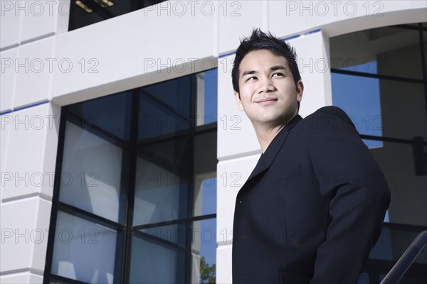 Asian businessman outside office building