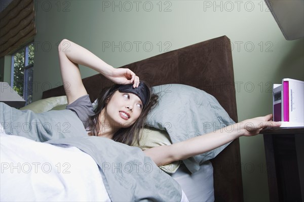 Woman waking to alarm clock