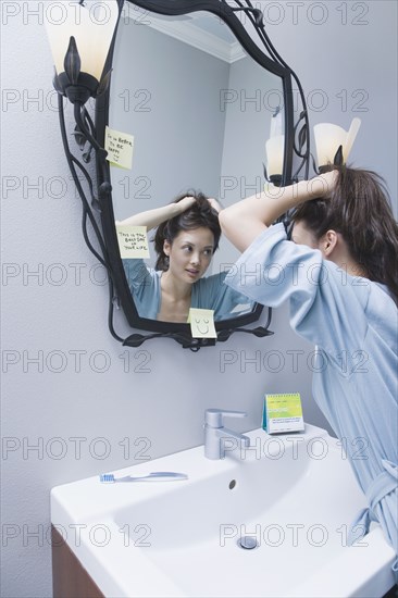 Woman getting ready in front of mirror