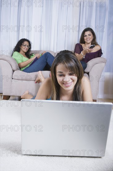 Multi-generational women using different forms of entertainment
