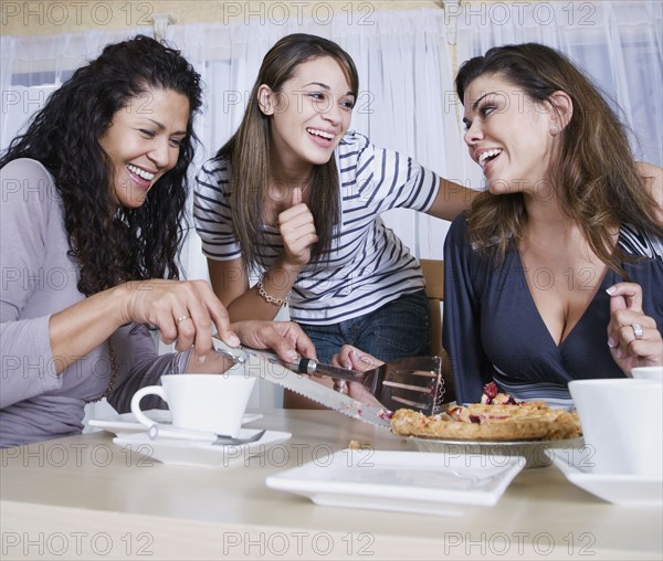 Multi-generational women eating homemade pie