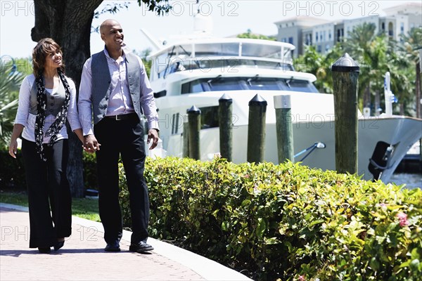 Couple walking on boardwalk and holding hands