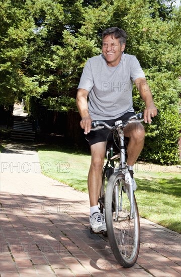 Caucasian man riding bicycle