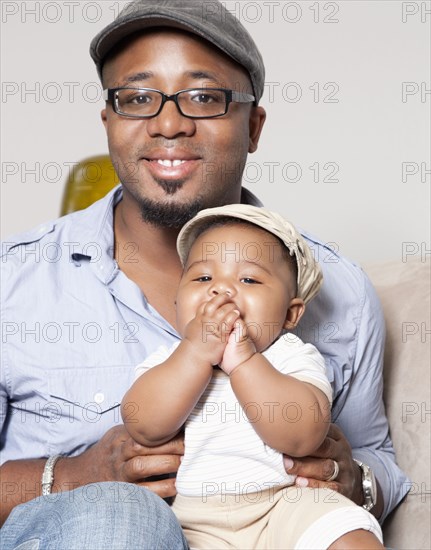 African American holding baby son in lap