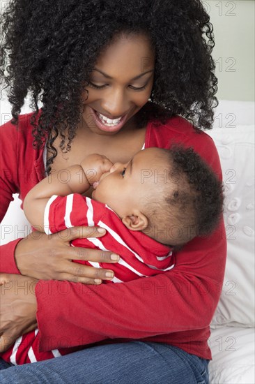 African American woman holding baby son