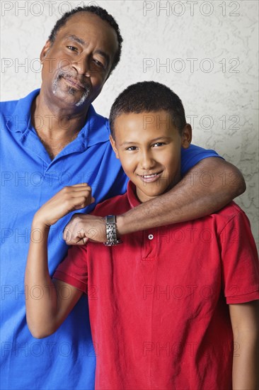 Black father hugging son