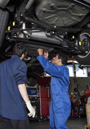 Mechanics working on car