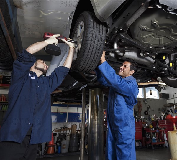 Mechanics working on car