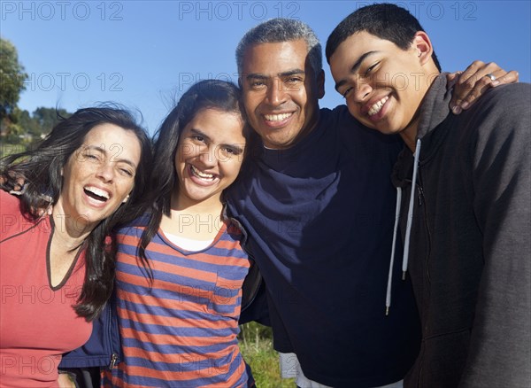 Hispanic family smiling in park