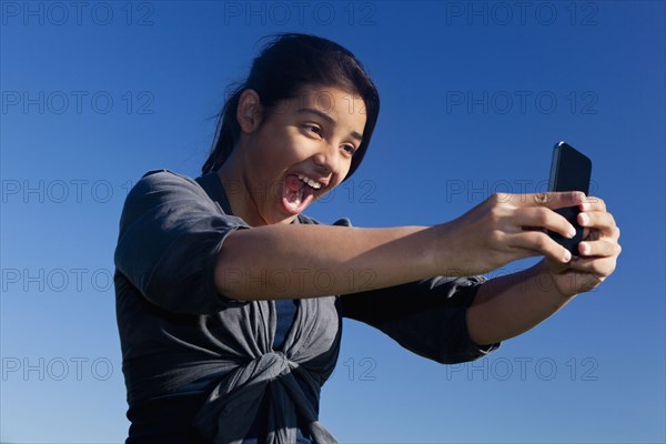 Hispanic teenage girl taking picture