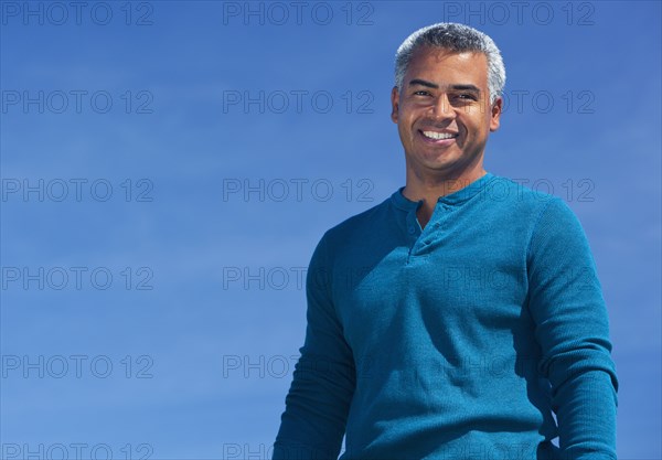 Mixed race man smiling outdoors