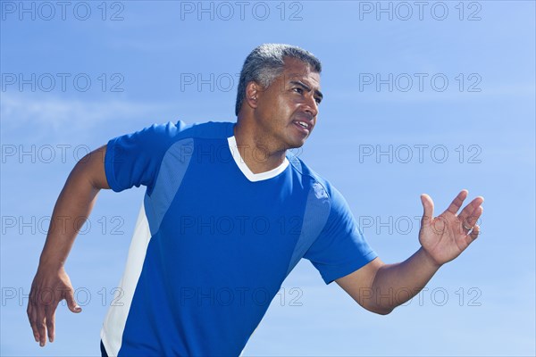 Mixed race man running outdoors