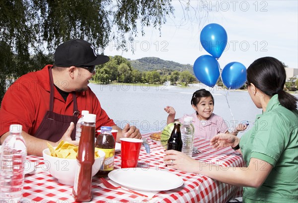 Family eating together at picnic