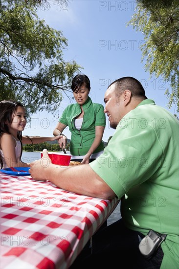 Family eating together at picnic