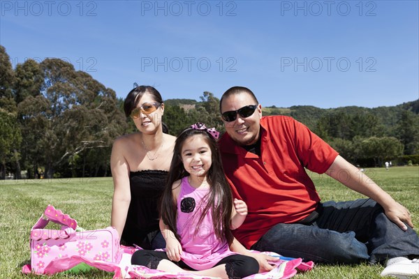 Family smiling together in grass