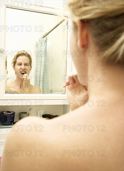 Caucasian woman brushing her teeth