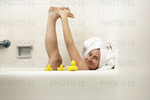 Caucasian woman playing in bath