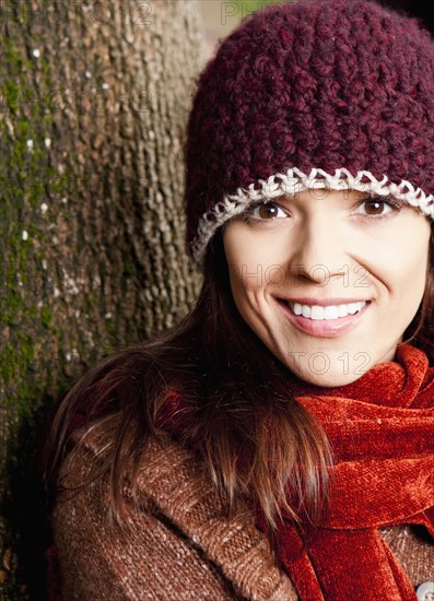 Mixed race woman wearing hat and scarf outdoors