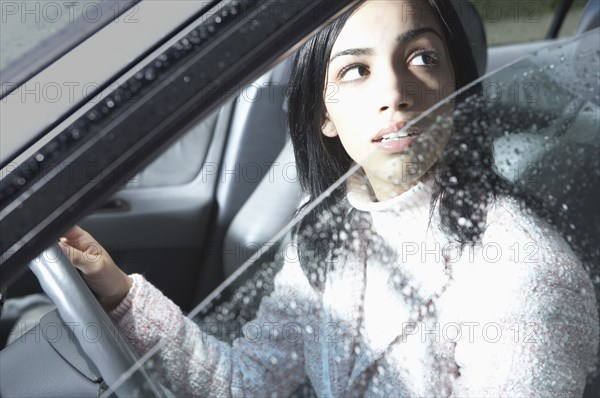 Indian woman looking out car window