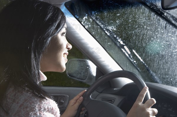 Indian woman driving in heavy rain