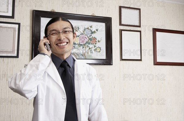 Mixed race doctor smiling in office