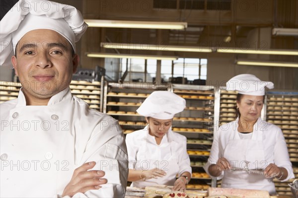 Hispanic bakers working in bakery
