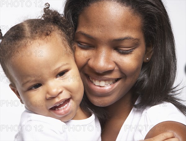 Smiling mother cradling baby