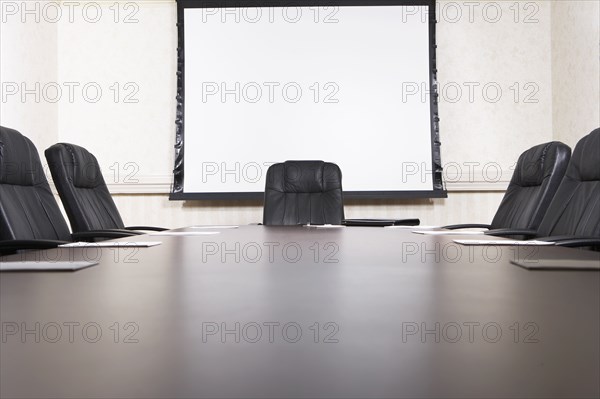 Empty chairs at conference table